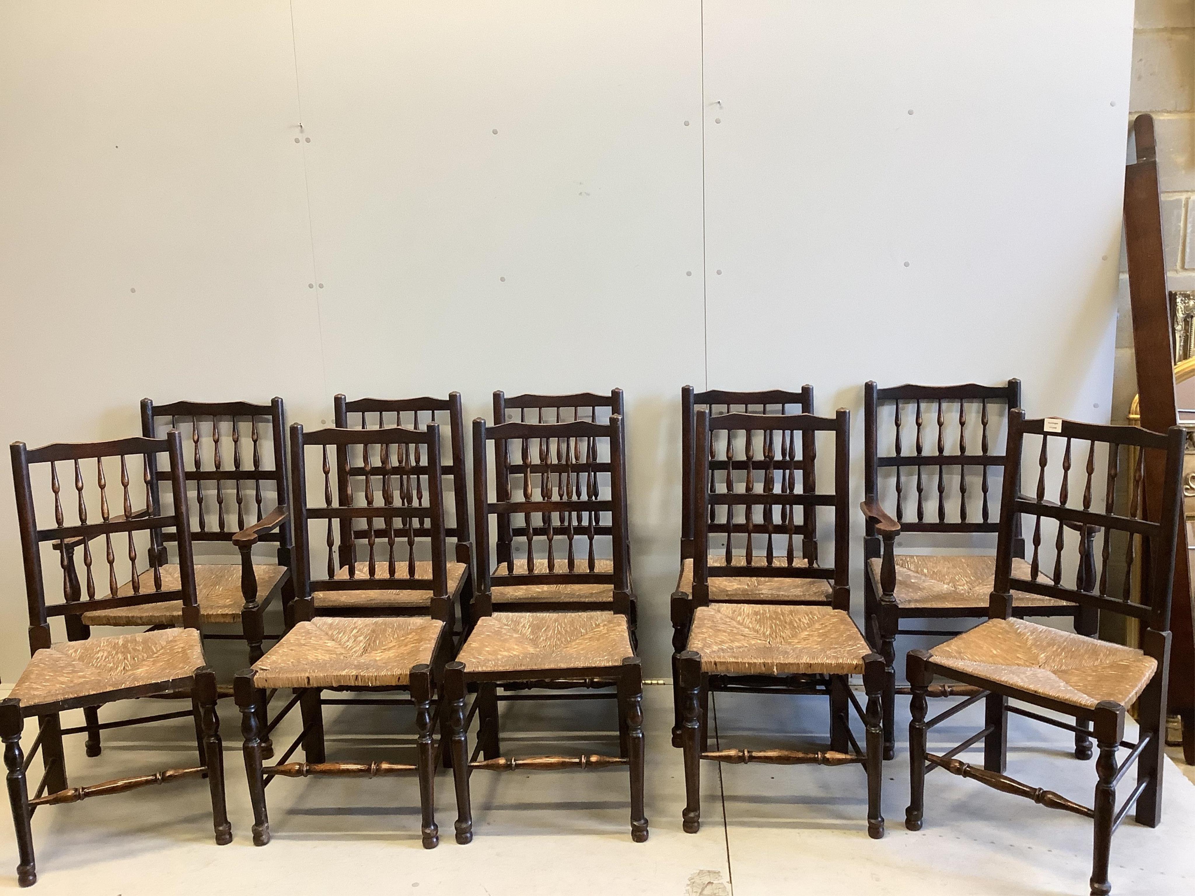 A set of ten ash spindle back chairs, two with arms. Condition - fair